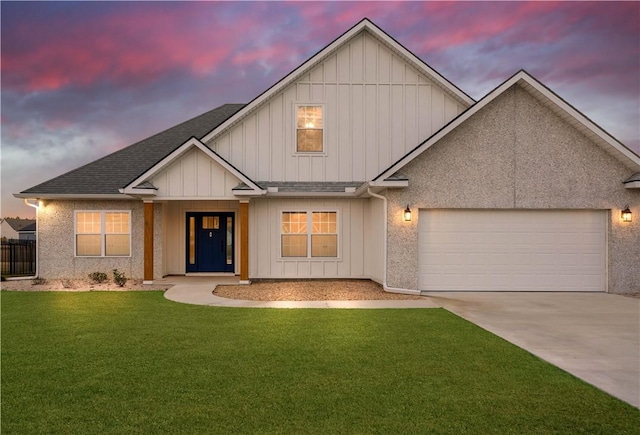 view of front facade with a garage and a yard