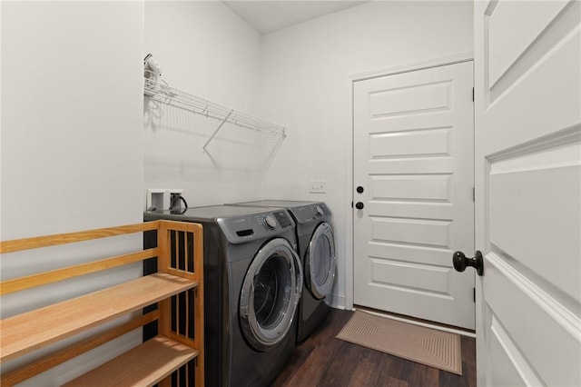 clothes washing area featuring dark hardwood / wood-style flooring and separate washer and dryer