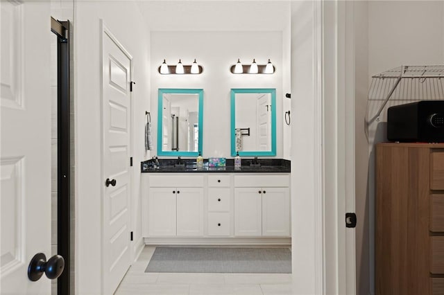 bathroom with tile patterned floors and vanity