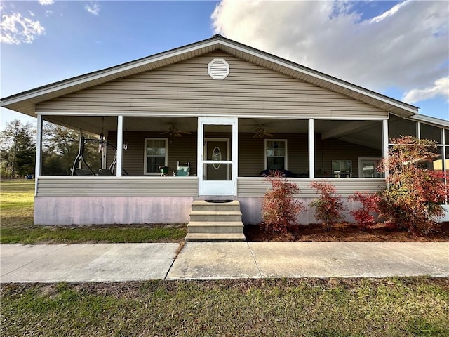 manufactured / mobile home with a porch, a ceiling fan, and a sunroom