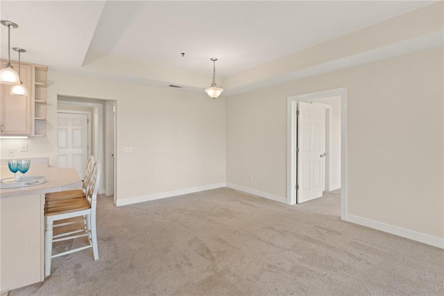 91 Screven St, Darien, GA 31305 - unfurnished dining area with light colored carpet and a raised ceiling