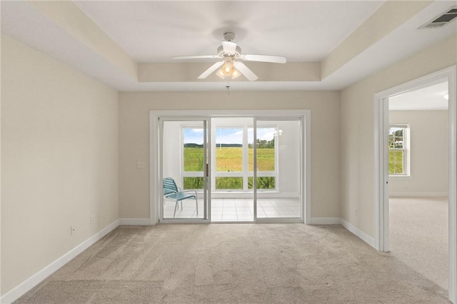 91 Screven St, Darien, GA 31305 - spare room featuring carpet flooring, a raised ceiling, and a ceiling fan
