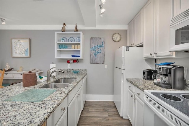 1175 N Beachview Dr Unit 414, Jekyll Island, GA 31527 - kitchen with a sink, track lighting, dark wood-style flooring, white appliances, and baseboards