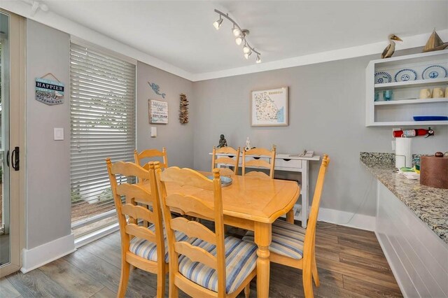 1175 N Beachview Dr Unit 414, Jekyll Island, GA 31527 - dining area with track lighting, dark wood-style floors, and baseboards