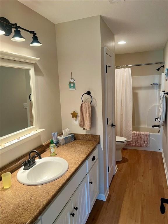 full bathroom featuring shower / bath combination with curtain, toilet, vanity, and wood finished floors