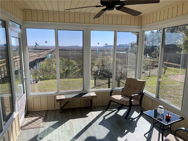 sunroom with a ceiling fan and wood ceiling