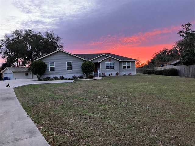 ranch-style home featuring a front yard and fence