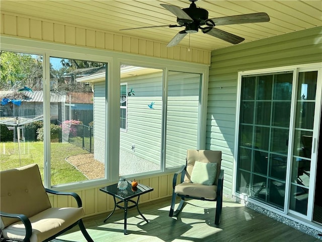 sunroom featuring wood ceiling and ceiling fan