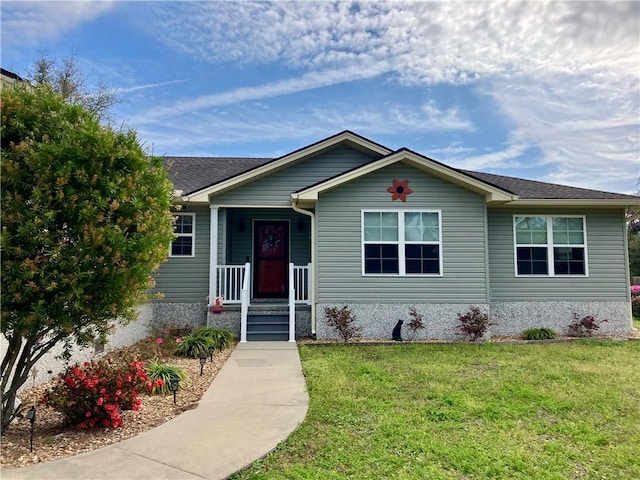 view of front of home featuring a front lawn and covered porch