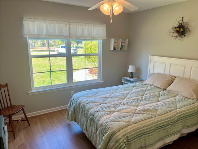 bedroom with baseboards and wood finished floors