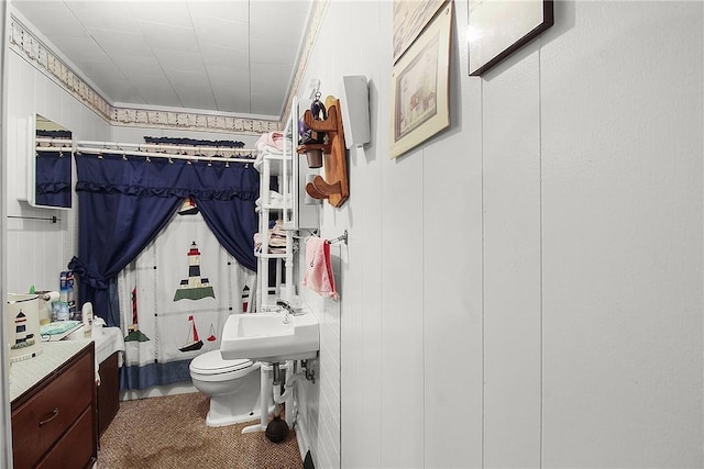 bathroom with ornamental molding, sink, walk in shower, and toilet