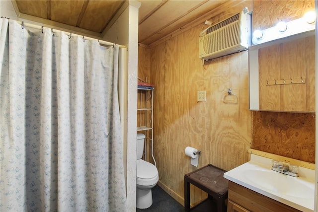 bathroom featuring vanity, a wall mounted air conditioner, wooden walls, and toilet