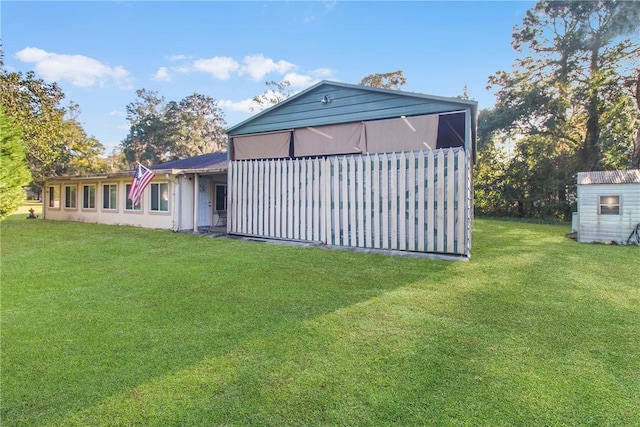 rear view of property featuring a lawn