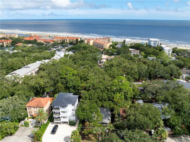 drone / aerial view featuring a water view and a view of the beach