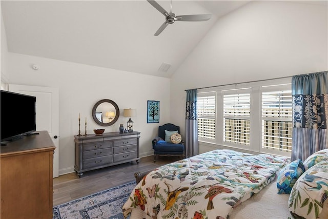 bedroom with ceiling fan, dark hardwood / wood-style flooring, and high vaulted ceiling