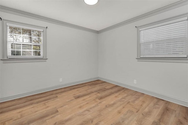 unfurnished room featuring light hardwood / wood-style floors and ornamental molding