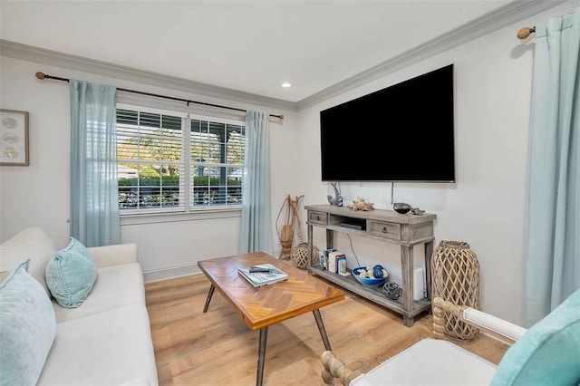 living room with wood-type flooring and ornamental molding