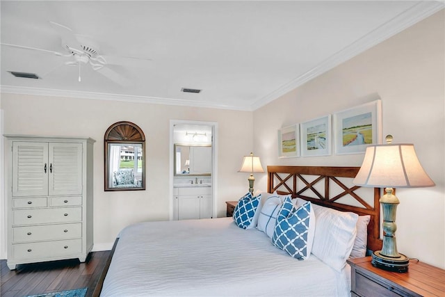 bedroom with dark wood-type flooring, visible vents, ensuite bathroom, and ornamental molding