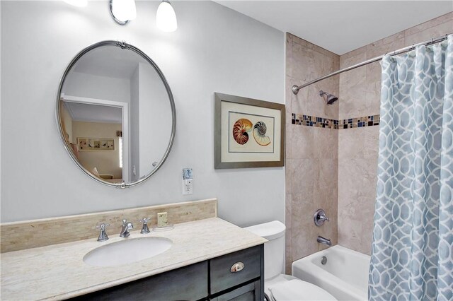 bathroom with vanity, toilet, and shower / bathtub combination with curtain