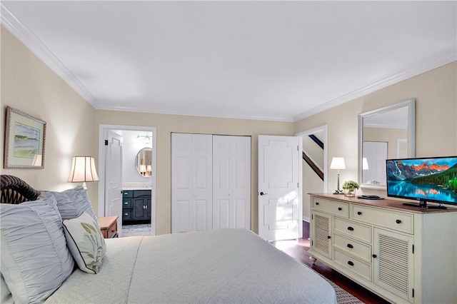 bedroom featuring a closet, ensuite bathroom, dark wood-type flooring, and crown molding