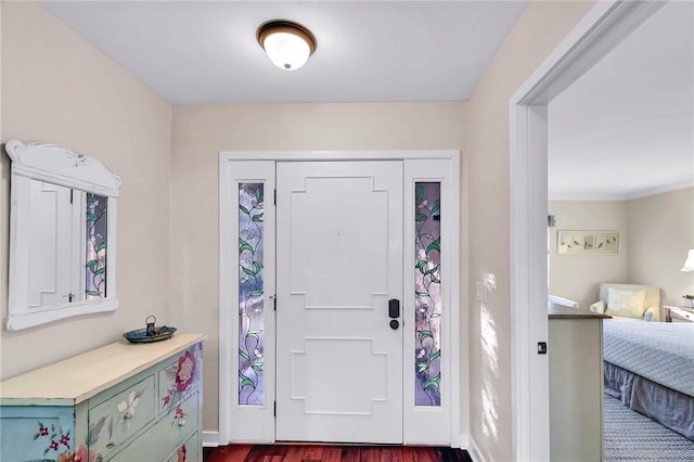 foyer entrance featuring dark wood-style floors and baseboards