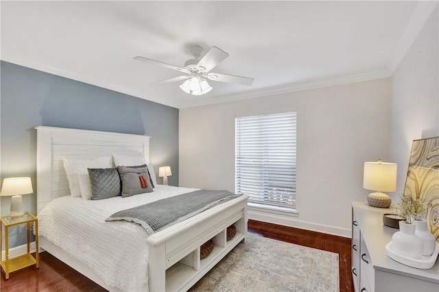 bedroom featuring dark hardwood / wood-style flooring, ceiling fan, and ornamental molding