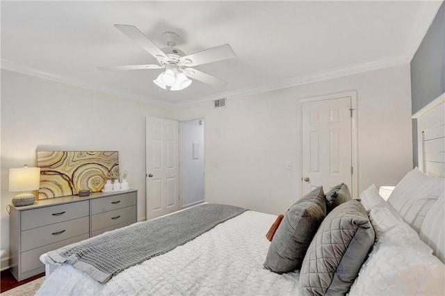 bedroom with ceiling fan, wood-type flooring, and crown molding