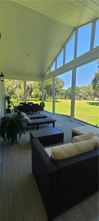 exterior space with lofted ceiling and a healthy amount of sunlight