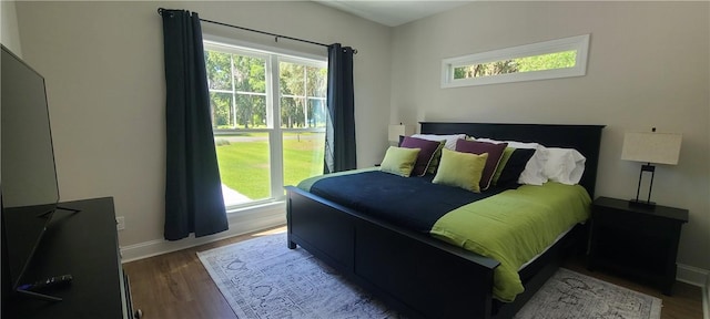 bedroom featuring baseboards and wood finished floors