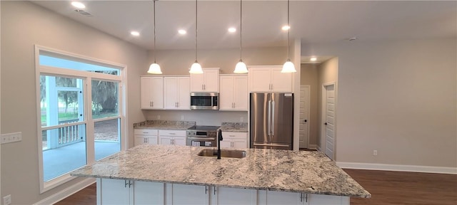 kitchen featuring dark wood-style floors, stainless steel appliances, a kitchen island with sink, white cabinets, and a sink