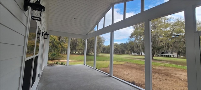 unfurnished sunroom with vaulted ceiling