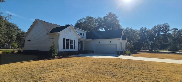 single story home with a front yard, concrete driveway, and an attached garage