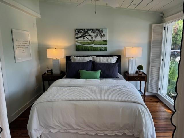 bedroom with dark wood-type flooring and access to outside