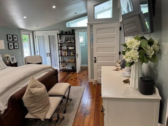 bedroom with lofted ceiling and wood-type flooring