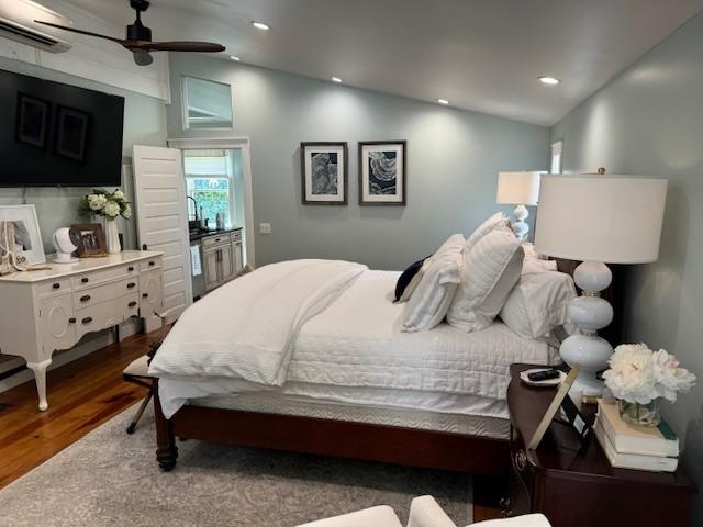 bedroom featuring dark wood-type flooring, ceiling fan, and lofted ceiling