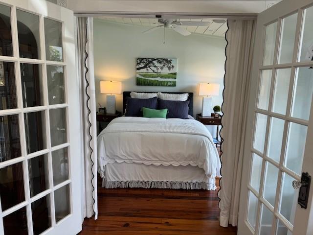 bedroom with ceiling fan and dark hardwood / wood-style floors