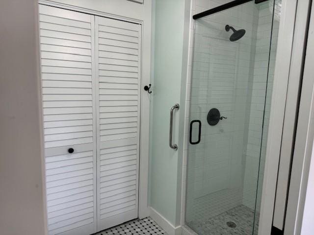 bathroom featuring a shower with shower door