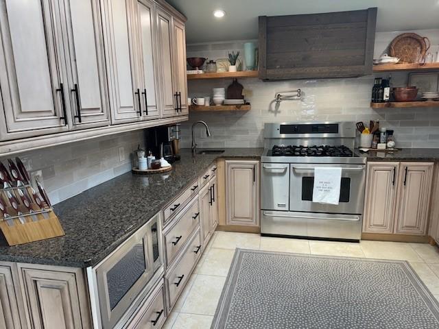 kitchen featuring light tile patterned floors, stainless steel appliances, and tasteful backsplash