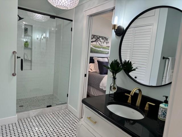 bathroom featuring vanity, tile patterned flooring, and a shower with door