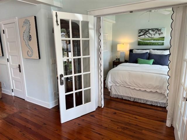 bedroom with dark hardwood / wood-style flooring