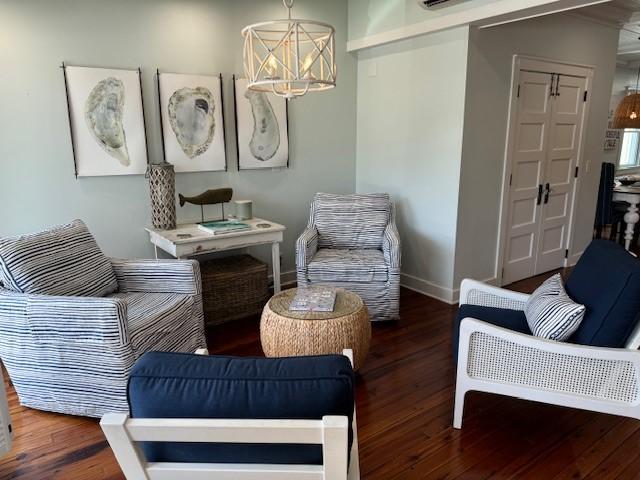 sitting room featuring dark hardwood / wood-style floors and a notable chandelier