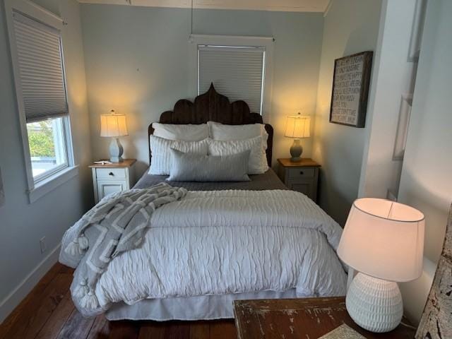 bedroom with dark wood-type flooring