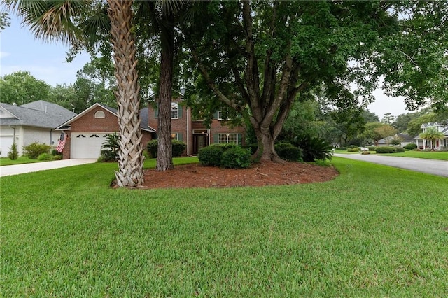 view of front of house featuring a front lawn and a garage