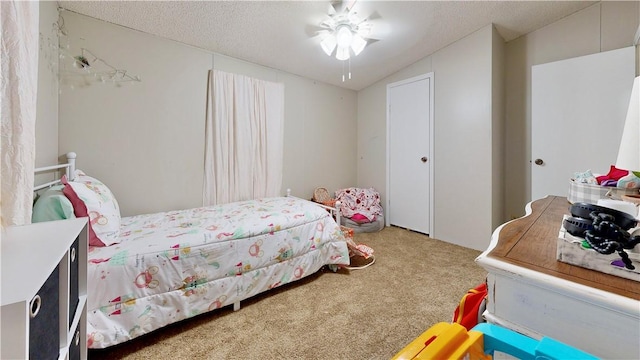 bedroom with carpet flooring, a textured ceiling, and lofted ceiling