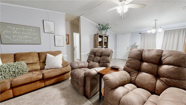 living area with vaulted ceiling, ceiling fan with notable chandelier, a textured ceiling, and wood finished floors