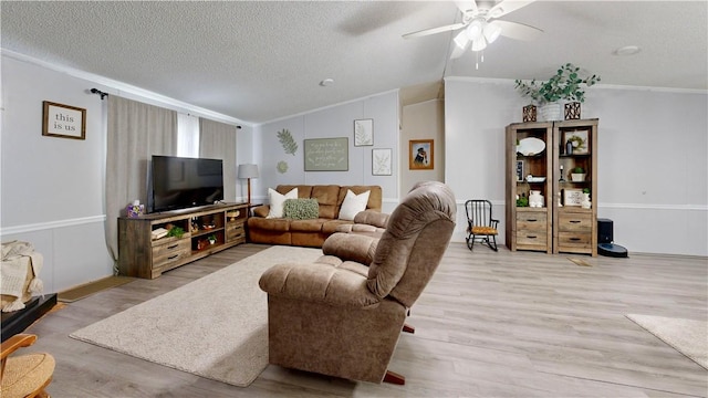 living area with crown molding, a textured ceiling, and vaulted ceiling