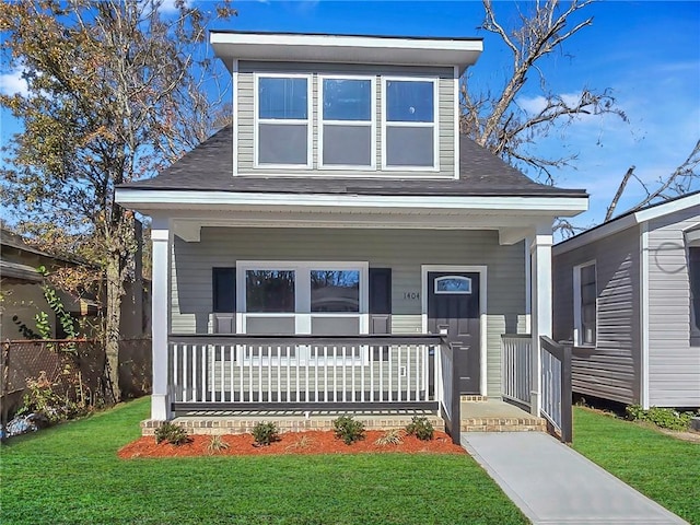 view of front of home featuring a front yard and a porch