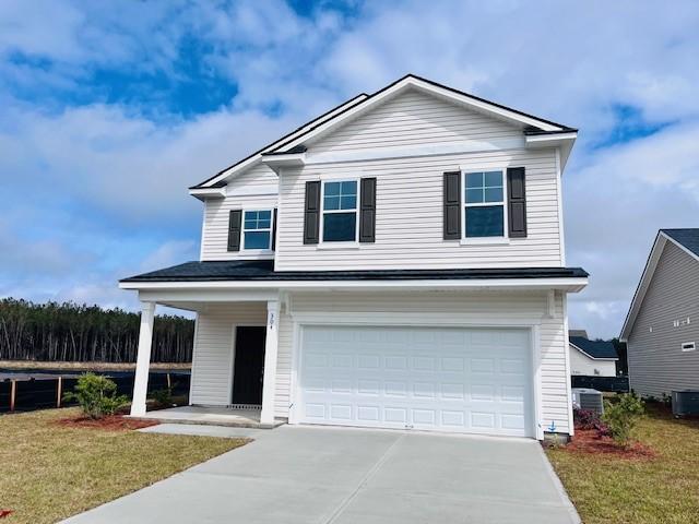 view of front facade with a garage, concrete driveway, and a front lawn