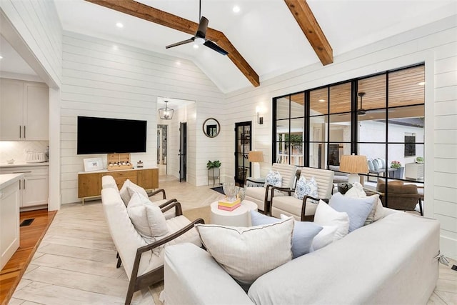 living room featuring beam ceiling, light hardwood / wood-style floors, high vaulted ceiling, and ceiling fan