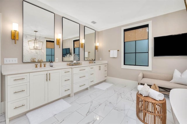 bathroom with vanity and an inviting chandelier